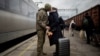 Ukrainian serviceman Vyacheslav greets his wife, Viktoria, who is visiting him during a short break from his frontline duty at the train station in Kramatorsk, Ukraine, on Dec. 22, 2023.