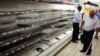 A worker checks empty shelves after removing processed meat products at a Pick n Pay Store in Johannesburg, South Africa, March 5, 2018, amid the country's worst listeria outbreak on record.