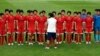 North Korean women's national soccer team players listen to head coach Kim Kwang Min after training session, Seoul World Cup stadium, South Korea, July 19, 2013.