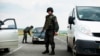 Ukrainian National Guard soldiers check cars while guarding a checkpoint outside of Slovyansk, eastern Ukraine, May 4, 2014. 