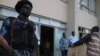 Togolese police forces stand guard at gate as electoral Commission members arrives with the ballot result papers on March 6, 2010 in Lome