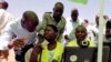 FILE - Officials from the Independent Electoral and Boundaries Commission (IEBC) assist residents to confirm their data during launch of 2017 general elections voter registration exercise within Kibera slums in Nairobi, January 16, 2017.