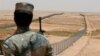 FILE - A member of the Saudi border guards force watches Saudi Arabia's northern borderline July 14, 2014. 