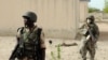 FILE - Nigerian soldiers are seen on patrol near a Boko Haram camp in the north of Borno state.