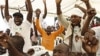 Supporters of opposition leader Alassane Ouattara, make their feelings known, as they sing at an event at a hotel in Abidjan, Ivory Coast, 30 Dec 2010