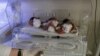 In this May 7, 2015 photo, new born Afghan babies are seen at Indira Gandhi children's hospital, and neonatal ward in Kabul, Afghanistan.