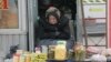 FILE - An elderly Ukrainian woman sells home made products in downtown Kyiv, Ukraine, Feb. 3, 2016. 