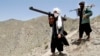 FILE - Afghan Taliban fighters are seen carrying weapons in a May 27, 2016, photo.