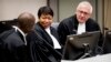 FILE - Prosecutor Fatou Bensouda (C) and Deputy Prosecutor James Stewart (R) attend the first audience with the chief of Central African Republic's soccer federation Patrice-Edouard Ngaissona at the International Criminal Court (ICC) in The Hague, the Netherlands, Jan. 25, 2019. 