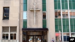 FILE — A man walks by the offices of the Diocese of Rockville Centre, on New York's Long Island, on Oct. 1, 2020. 