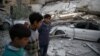 Children are seen near rubble after an airstrike in the besieged town of Douma, in eastern Ghouta, near Damascus, Syria, Feb. 6, 2018.