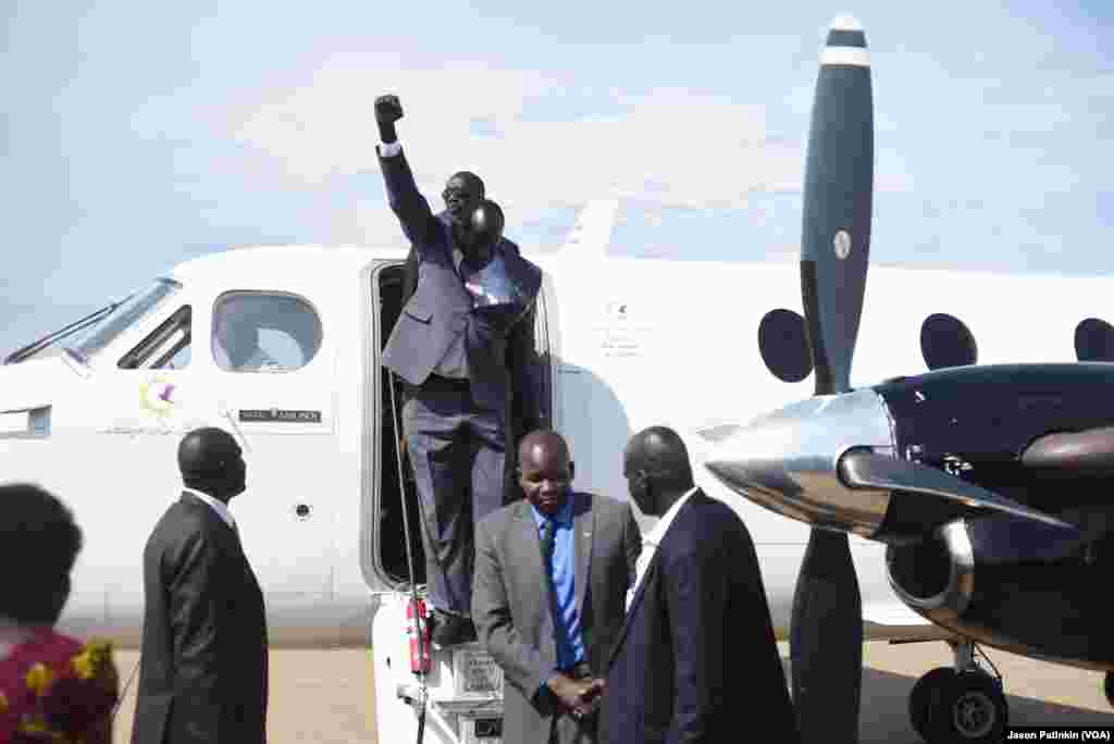 Second-in-command of South Sudan's rebels, Alfred Lado Gore, raises his fist after landing in the capital Juba, after more than two years in exile, April 12, 2016. Rebel leader Riek Machar is scheduled to return on April 18.