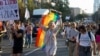 While police protect them, pride marchers demand better rights in Serbia