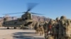 FILE - U.S. soldiers, part of a NATO-led force, load onto a Chinook helicopter to head out on a mission in Afghanistan, Jan. 15, 2019.