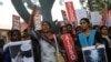 A member of a students organization shouts slogans as others carry placards asking justice for Asifa Mohammad Yusuf Pujwala, an 8-year-old girl who was raped and murdered, during a protest in Bangalore, India, April 13, 2018. Thousands of members of a radical Hindu group with links to the ruling party have marched to demand the release of six men accused in the repeated rape and murder of the Muslim girl inside a Hindu temple. Hundreds of Hindu lawyers have protested that the men, two of them police officers, are innocent.