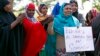 Somali women listen to a speaker at a solidarity rally to denounce al Shabaab's attack of a shopping mall in Nairobi, in Minneapolis, Minnesota, Sept. 27, 2013. 