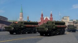 FILE - Russian servicemen drive S-400 missile air defense systems during the Victory Day parade in Moscow, May 9, 2018.