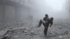 A wounded man is carried following an airstrike on the rebel-held besieged town of Arbin, in the eastern Ghouta region on the outskirts of the capital Damascus, Jan. 2, 2018.
