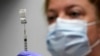 FILE - In this March 2, 2021, file photo, pharmacy technician Hollie Maloney loads a syringe with Pfizer's COVID-19 vaccine at the Portland Expo in Portland, Maine. The U.S. gave full approval to Pfizer's COVID-19 vaccine on Monday, Aug. 23, 2021. (AP Photo/Robert F. Bukaty, File