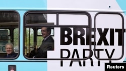Brexit Party leader Nigel Farage and Mike Greene, Brexit Party candidate for the forthcoming Peterborough by-election, ride a campaign bus in Peterborough, Britain, May 9, 2019. 