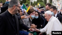 El papa Francisco saluda a un grupo de fieles durante una visita a una escuela católica en Atenas, Grecia, el 6 de diciembre de 2021.