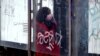 BOSNIA-HERZEGOVINA -- A woman wearing face mask walks on a street in the midst of the coronavirus disease (COVID-19) pandemic, in Sarajevo, December 18, 2020