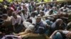 A Kenyan student is prodded in the head by a riot policeman's club inside Nairobi University's main campus in downtown Nairobi, May 20, 2014