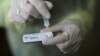 FILE - A health care worker holds a rapid COVID-19 antigen test at a coronavirus testing center in Nice, France, Oct. 15, 2020. Millions of such kits are heading to Africa for distribution.