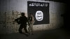 FILE - An Iraqi soldier inspects a former train tunnel displaying the the Islamic State group flag, in western Mosul, Iraq, March 1, 2017. The tunnel once served as a training camp for IS fighters.