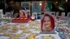 Souvenirs with pictures of Bangladesh Prime Minister Sheikh Hasina, front, and others are put up for sale at a roadside shop ahead of the general elections in Dhaka, Bangladesh, Friday, Dec. 28, 2018. 
