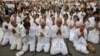 People wearing white pray as they mourn Cambodia's former King Norodom Sihanouk in front of the Royal Palace in Phnom Penh, October 15, 2012.