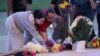 People lay flowers while attending a vigil at Jug Tavern Park following a shooting at Apalachee High School in Winder, Georgia, Sept. 4, 2024. 