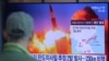 FILE - A man watches a TV screen showing a file image of North Korea's missile launch during a news program at the Seoul Railway Station in Seoul, South Korea, March 29, 2020.