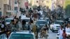 FILE - Fighters from the Islamic State group parade in Raqqa, north Syria, June 30, 2014. Islamic State militants are cracking down on the few remaining Christians and preventing them from leaving Raqqa, Syria, local activists told VOA on April 5, 2016.