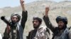 FILE - Taliban fighters react to a speech by their senior leader in the Shindand district of Herat province, Afghanistan. 