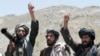 FILE - Taliban fighters react to a speech by their senior leader in the Shindand district of Herat province, Afghanistan. 