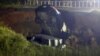 In this image made from video and provided by WLOX-TV, a vehicle is extracted from a hole on highway 26, Tuesday, Aug. 31, 2021, near Lucedale, Miss. (WLOX-TV via AP)