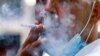 FILE - A Jordanian man smokes a cigarette in the capital Amman, March 17, 2021. 