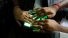 FILE - An operator helps an elderly woman scan her fingerprints as she enrolls for Aadhar, India's unique identification project in Kolkata, India, May 16, 2012. 