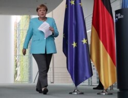 German Chancellor Angela Merkel arrives for a press conference at the Chancellery in Berlin, Germany, Aug. 19, 2020.