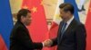 FILE - Philippine President Rodrigo Duterte (L) and Chinese President Xi Jinping shake hands after a signing ceremony held in Beijing, Oct. 20, 2016. 