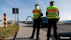 FILE - Members of the German federal police patrol along the German-Polish border area as part of efforts to detain migrants from Belarus, in Frankfurt-an-der-Oder, Germany, Oct. 28, 2021. 