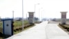 FILE - A North Korean soldier looks out from a sentry as he stands guard at an entrance to the Hwanggumpyong Economic Zone near the North Korean town of Sinuiju, opposite China's border city of Dandong.