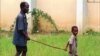 FILE - A child leads a man affected by river blindness in Gbarnga, Liberia, Sept. 4, 1995. 