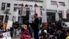 A professor speaks to students during a protest outside Taiwan&#39;s legislature in Taipei, March 20, 2014. Hundreds of protesters in Taiwan opposed to a trade pact with China which they fear gives the mainland too much economic influence and access to opport