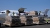 FILE - Workers unload an aid shipment from a plane at the Sanaa airport, Yemen, Nov. 25, 2017. 