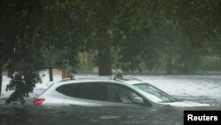 A vehicle is submerged in flood waters in Jourdan River Shores neighborhood as Hurricane Isaac passes through Kiln, Mississippi, August 29, 2012. 