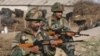 FILE - Indian army soldiers stand guard near the Indian Air Force (IAF) base at Pathankot in Punjab, India, Jan. 3, 2016. India's government has disciplined NDTV Hindi channel for related coverage, drawing media protest.