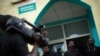 FILE - People with black tape covering their mouths attend a press conference of local journalists to mark World Press Freedom Day at the offices of the Iwacu media group in Bujumbura, Burundi, May 3, 2015. 