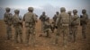FILE - In this photo released by the U.S. Army, U.S. soldiers gather for a briefing during a combined joint patrol rehearsal in Manbij, Syria, Nov. 7, 2018.